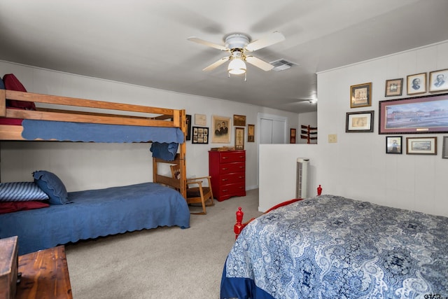 carpeted bedroom with a ceiling fan and visible vents