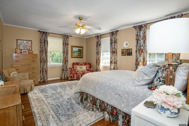 bedroom with ornamental molding, ceiling fan, and wood finished floors