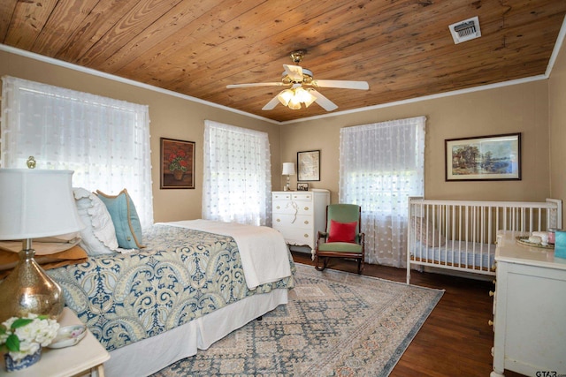 bedroom featuring visible vents, ornamental molding, wood finished floors, and wood ceiling