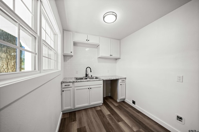 laundry room featuring sink and dark wood-type flooring