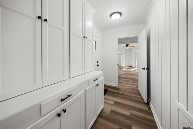 hall with crown molding and dark wood-type flooring