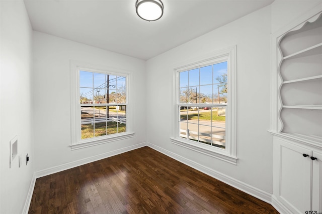 empty room with dark hardwood / wood-style floors