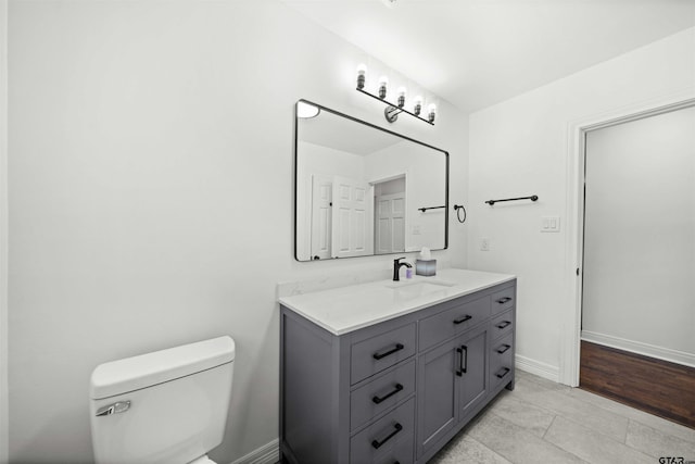 bathroom with tile patterned floors, vanity, and toilet