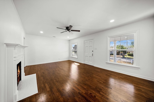 unfurnished living room with ceiling fan and dark wood-type flooring