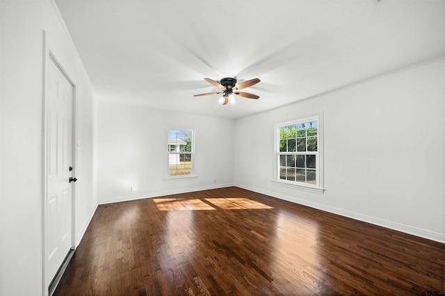 unfurnished room featuring a wealth of natural light, ceiling fan, and dark wood-type flooring