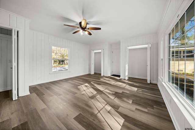 unfurnished bedroom featuring ceiling fan and dark hardwood / wood-style flooring