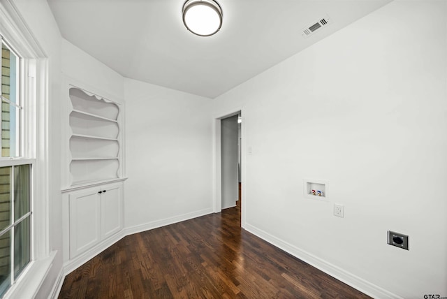 empty room with dark hardwood / wood-style flooring