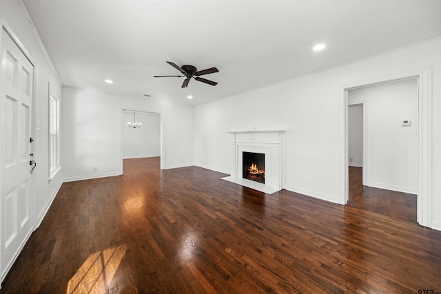 unfurnished living room featuring dark hardwood / wood-style flooring and ceiling fan with notable chandelier