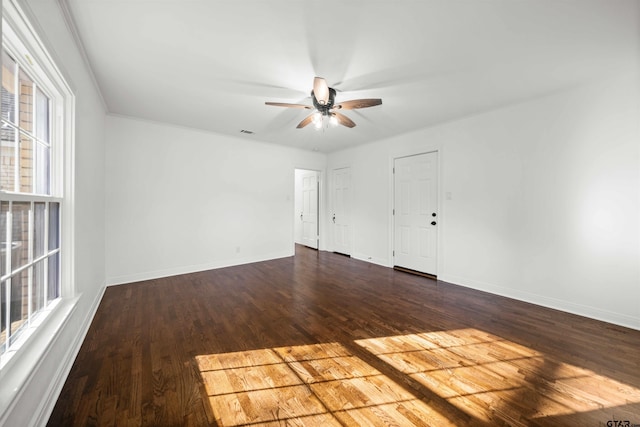 empty room with dark hardwood / wood-style flooring and ceiling fan