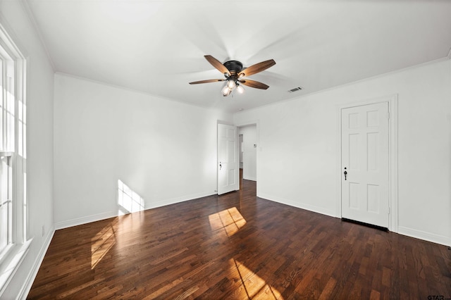 unfurnished room featuring ceiling fan, dark hardwood / wood-style floors, and ornamental molding