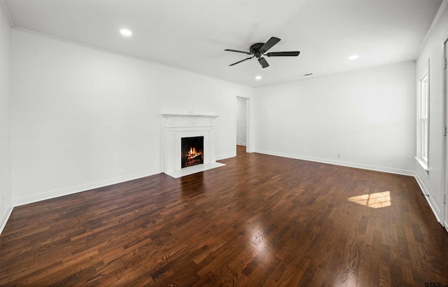 unfurnished living room featuring ceiling fan, dark hardwood / wood-style flooring, and crown molding