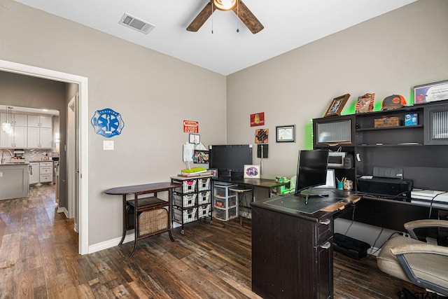 office area featuring baseboards, visible vents, wood finished floors, and a ceiling fan