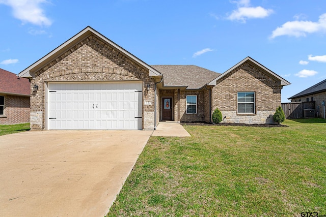 single story home with driveway, a front yard, a garage, and brick siding