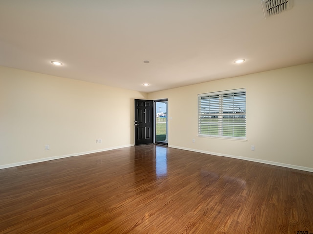 spare room featuring dark wood-type flooring