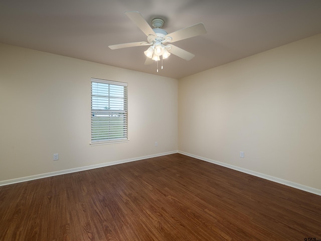 unfurnished room featuring ceiling fan and dark hardwood / wood-style floors