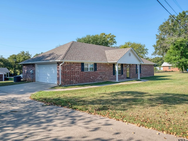 ranch-style home with central AC unit, a garage, and a front yard