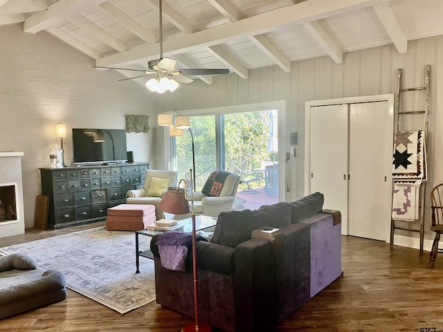 living room featuring vaulted ceiling with beams, dark hardwood / wood-style floors, and ceiling fan