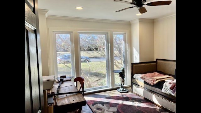 bedroom with ornamental molding and ceiling fan