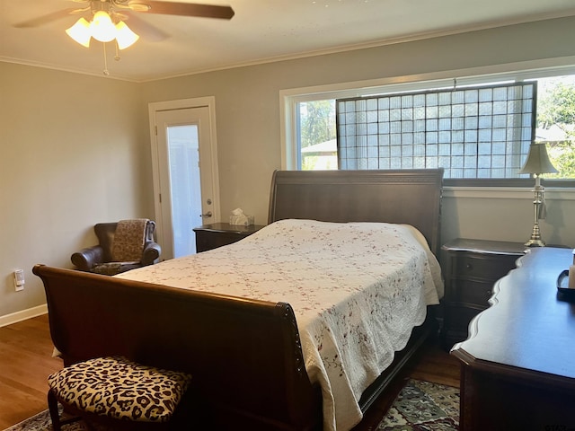 bedroom with wood-type flooring, ornamental molding, and ceiling fan