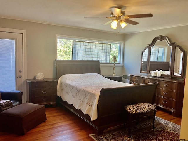 bedroom featuring crown molding, hardwood / wood-style flooring, and ceiling fan