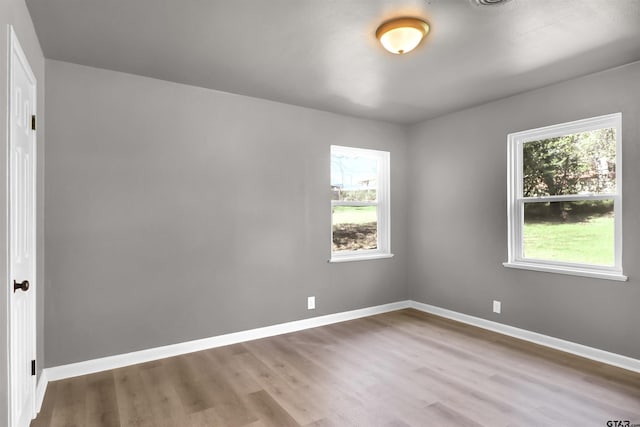 spare room with wood-type flooring