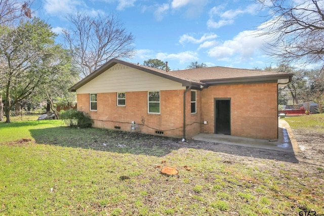 rear view of house featuring a yard and a patio area