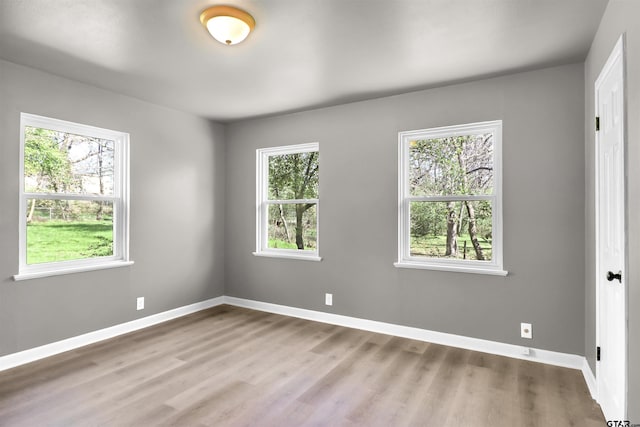 unfurnished room with light hardwood / wood-style flooring