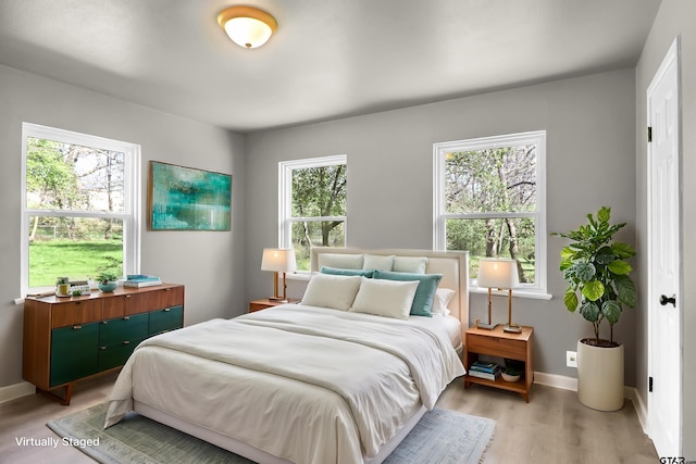 bedroom with light hardwood / wood-style flooring