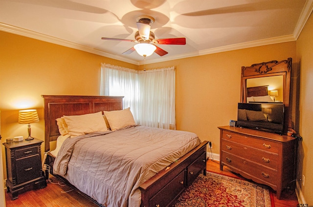 bedroom featuring hardwood / wood-style flooring, ceiling fan, and crown molding