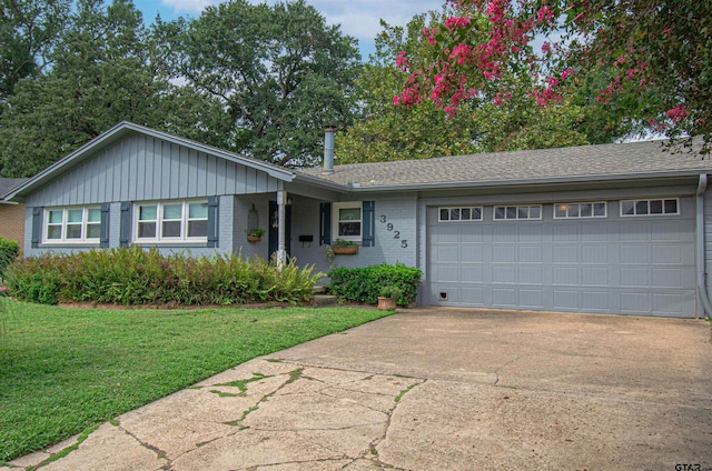 single story home featuring a garage and a front yard