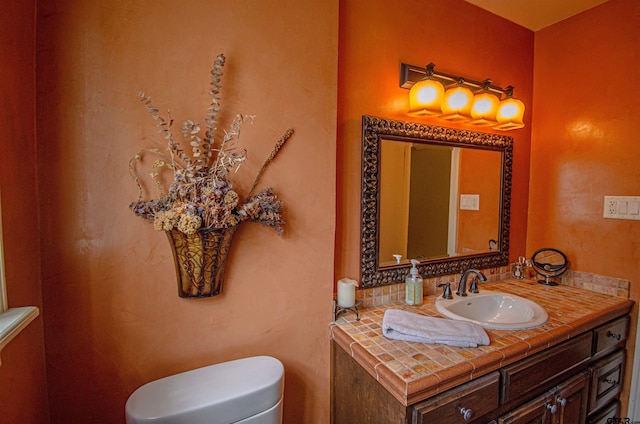 bathroom featuring toilet and vanity