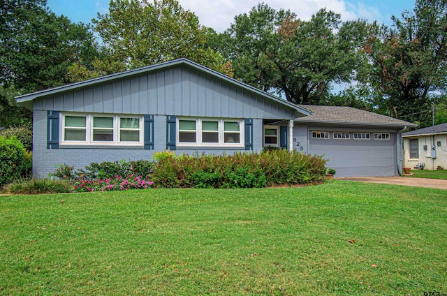 single story home featuring a garage and a front lawn