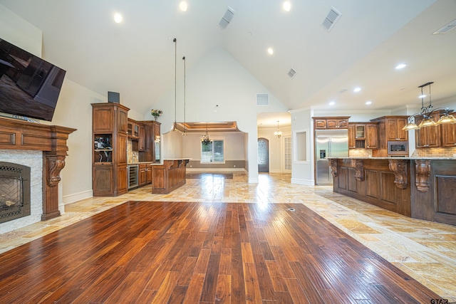 living room featuring wine cooler, high vaulted ceiling, and light hardwood / wood-style floors