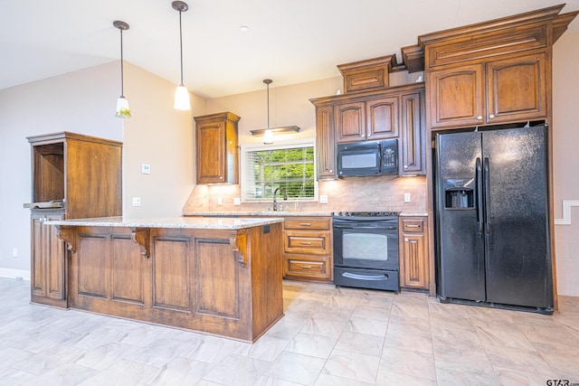 kitchen with backsplash, black appliances, decorative light fixtures, light stone counters, and a breakfast bar area