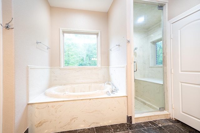 bathroom featuring shower with separate bathtub