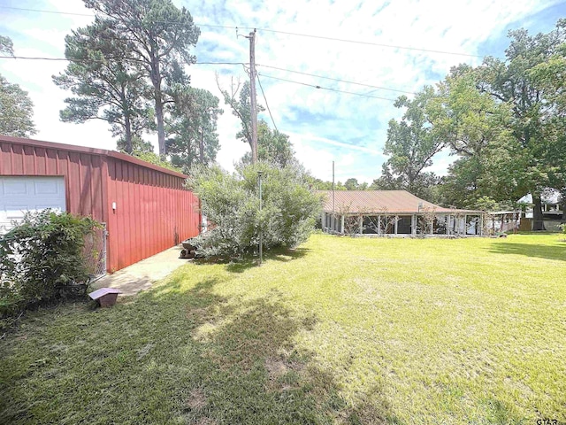 668 Omaha Dr, Omaha, TX 75571 - view of green lawn featuring an outbuilding and a garage