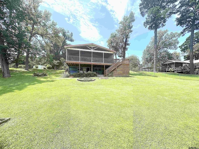 668 Omaha Dr, Omaha, TX 75571 - rear view of house with a sunroom, stairway, a lawn, and a wooden deck