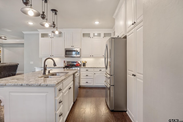 kitchen featuring dark wood-type flooring, a sink, white cabinetry, appliances with stainless steel finishes, and glass insert cabinets