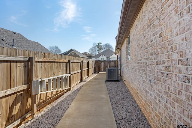 view of yard featuring central air condition unit and a fenced backyard