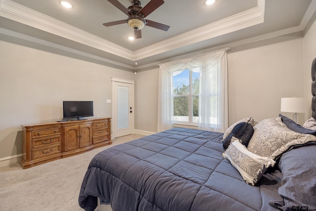 bedroom with light carpet, a raised ceiling, a ceiling fan, crown molding, and baseboards