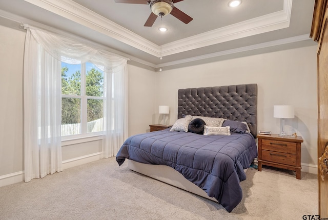 carpeted bedroom featuring crown molding, baseboards, a tray ceiling, recessed lighting, and a ceiling fan