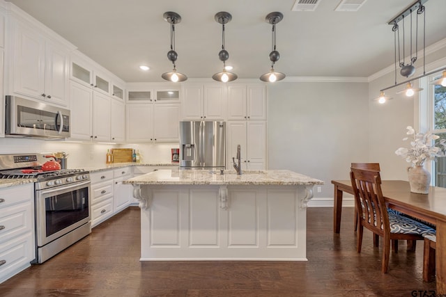 kitchen with a sink, white cabinetry, stainless steel appliances, crown molding, and glass insert cabinets