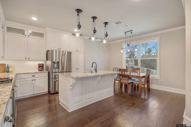 kitchen with dark wood-style floors, visible vents, light stone countertops, stainless steel appliances, and crown molding