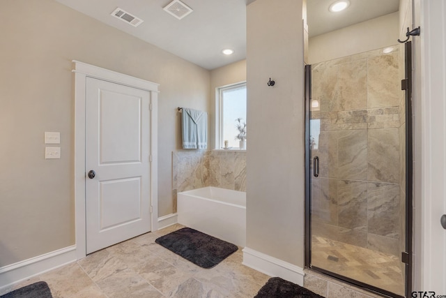 full bath featuring a garden tub, baseboards, visible vents, and a stall shower