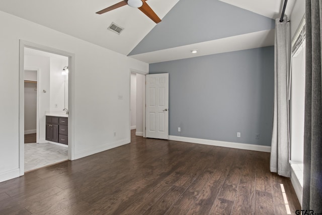 501 Morning Glory Cir, Hughes Springs, TX 75656 - unfurnished bedroom featuring vaulted ceiling, visible vents, a sink, connected bathroom, and dark wood-type flooring