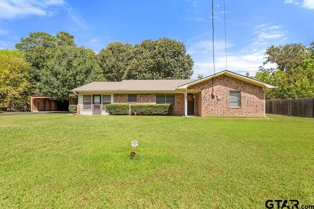 single story home featuring a front lawn