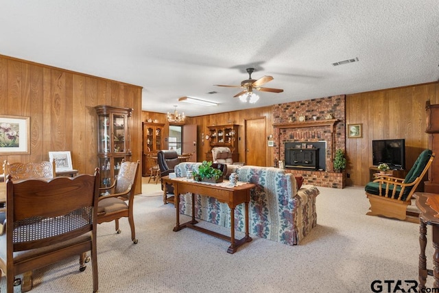 living room with light colored carpet, wooden walls, and ceiling fan