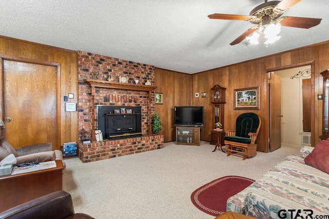 21187 Kristen Dr, Chandler, TX 75758 - carpeted living area featuring wooden walls, a ceiling fan, a textured ceiling, and ornamental molding
