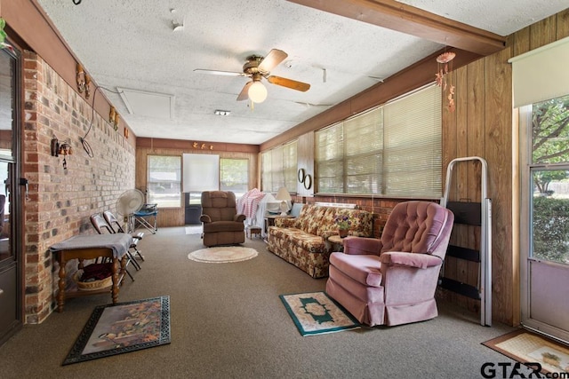 sunroom / solarium with ceiling fan and beam ceiling