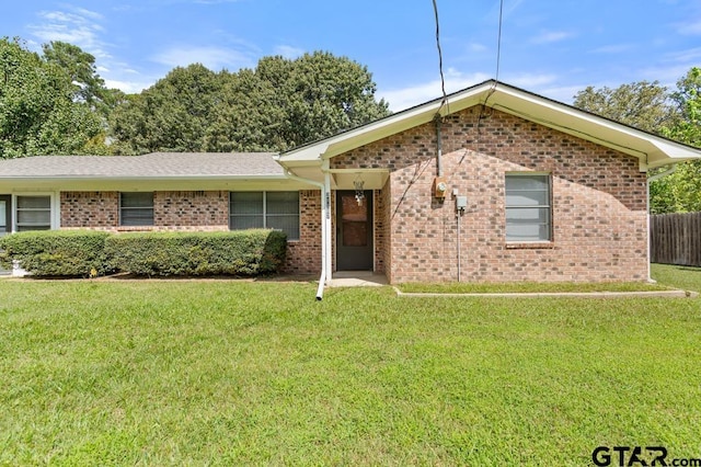 ranch-style home with a front lawn